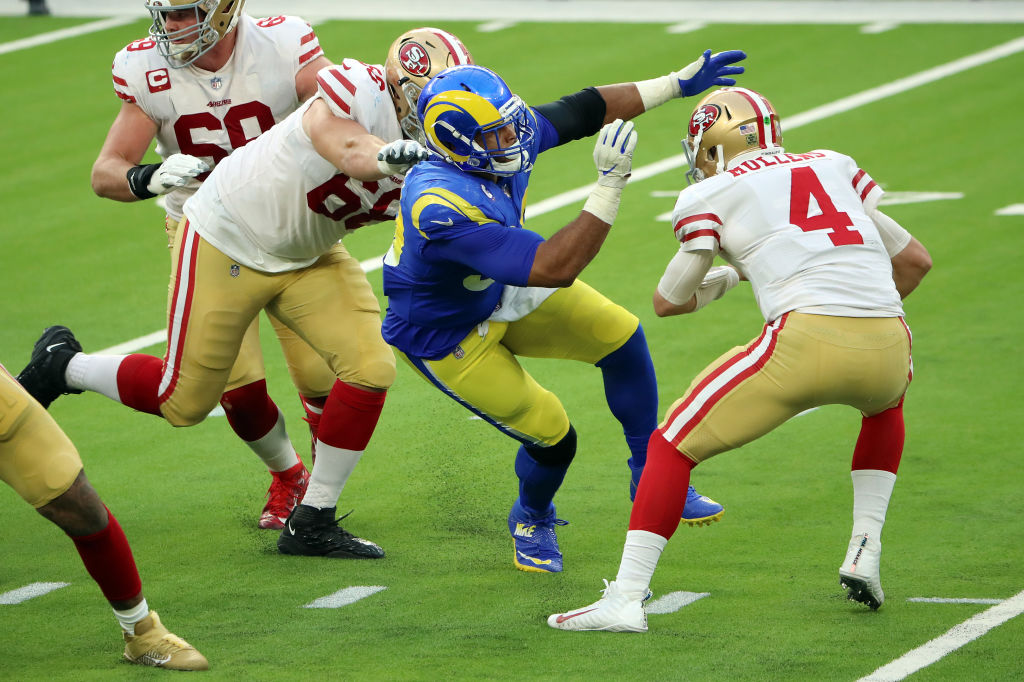 Aaron Donald #99 of the Los Angeles Rams attempts to sack Nick Mullens #4 of the San Francisco 49er...