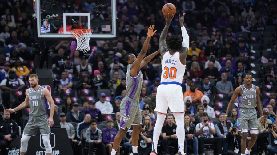 Julius Randle #30 of the New York Knicks shoots over Harrison Barnes #40 of the Sacramento Kings during the first half of an NBA basketball gaem at Golden 1 Center on March 09, 2023 in Sacramento, California.