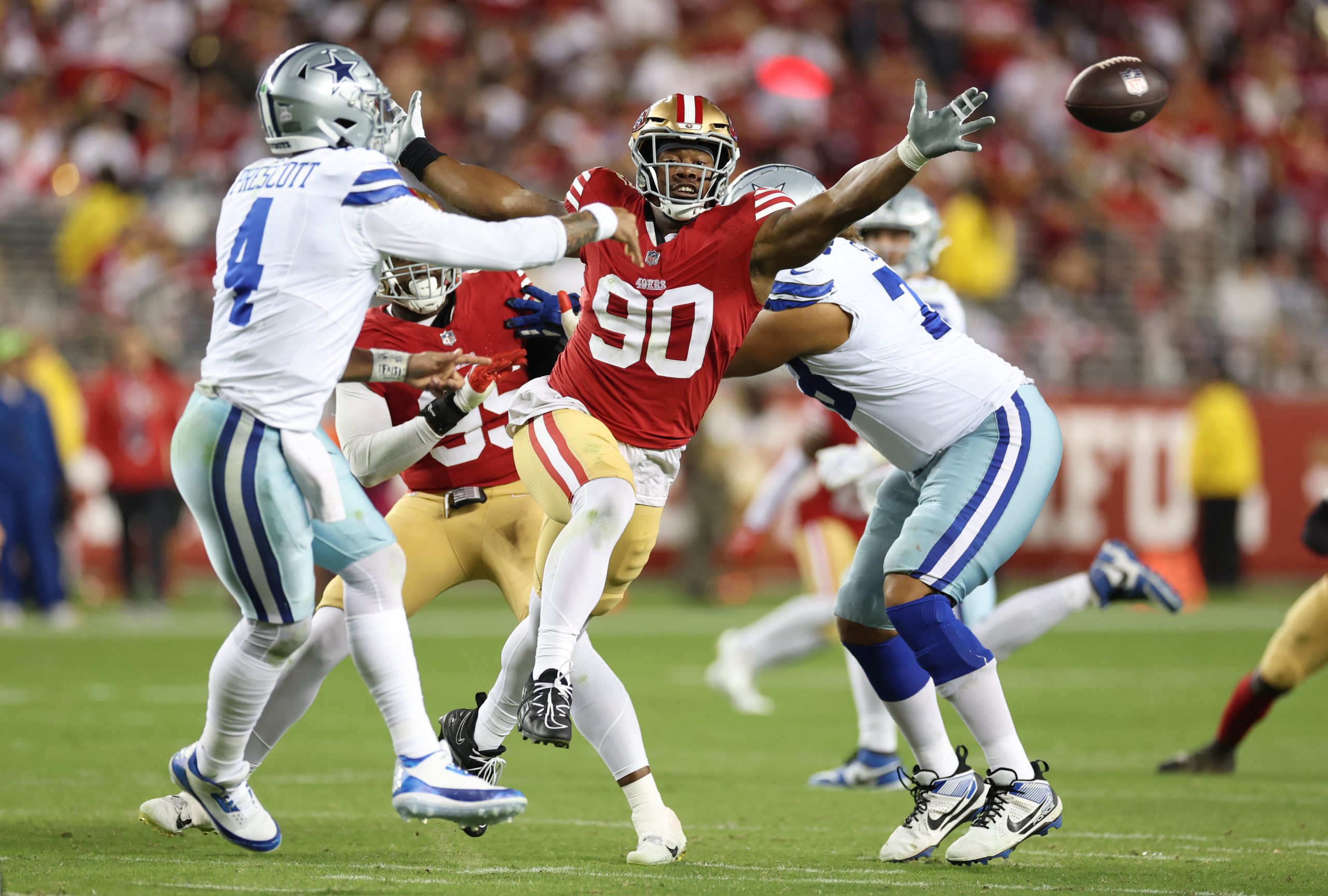 Kevin Givens #90 of the San Francisco 49ers pressures Dak Prescott #4 of the Dallas Cowboys during ...
