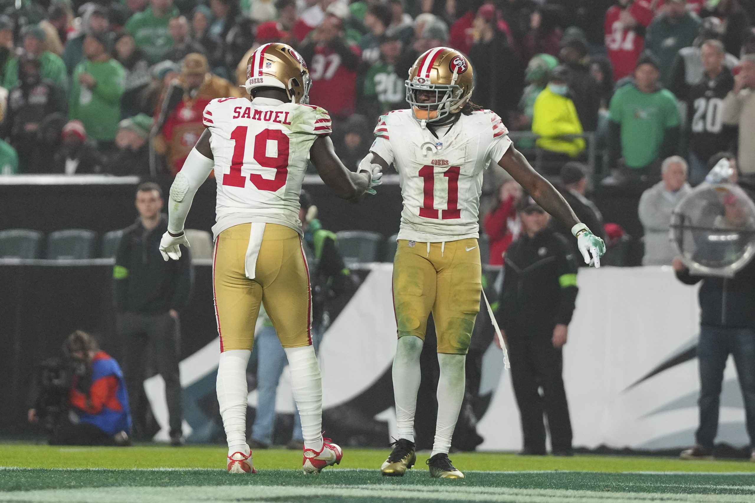 Deebo Samuel #19 of the San Francisco 49ers celebrates with Brandon Aiyuk #11 after scoring a touch...