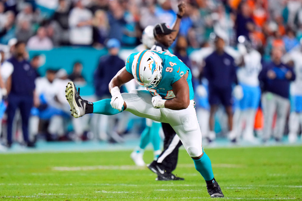 Christian Wilkins #94 of the Miami Dolphins celebrates with teammates after a sack in the first hal...