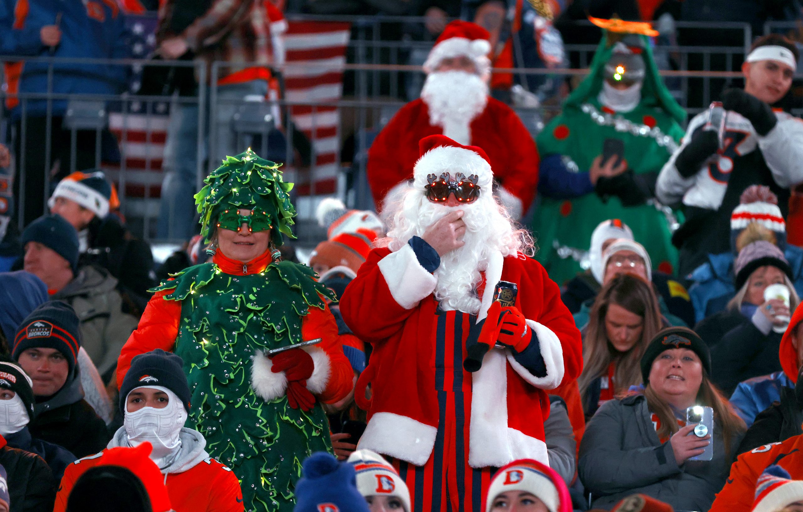 Fans in Christmas costumes watch from the stands prior to the game between the Denver Broncos and t...