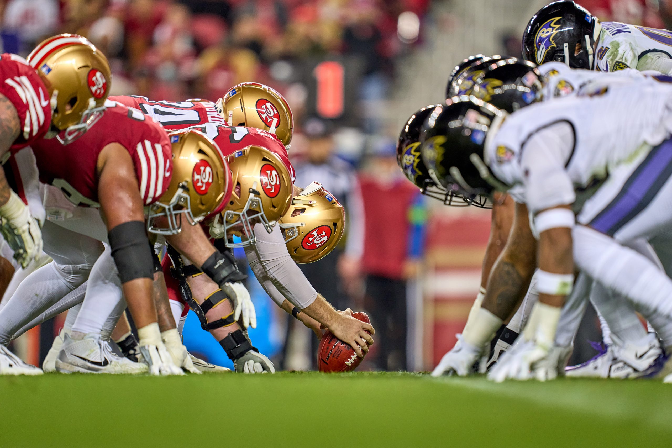 The San Francisco 49ers offensive line is seen with the Baltimore Ravens defensive line at the line...