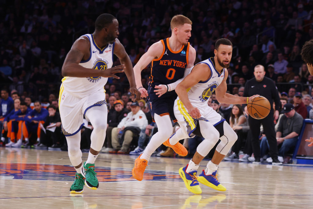 Stephen Curry #30 of the Golden State Warriors drives to the basket against Donte DiVincenzo #0 of ...