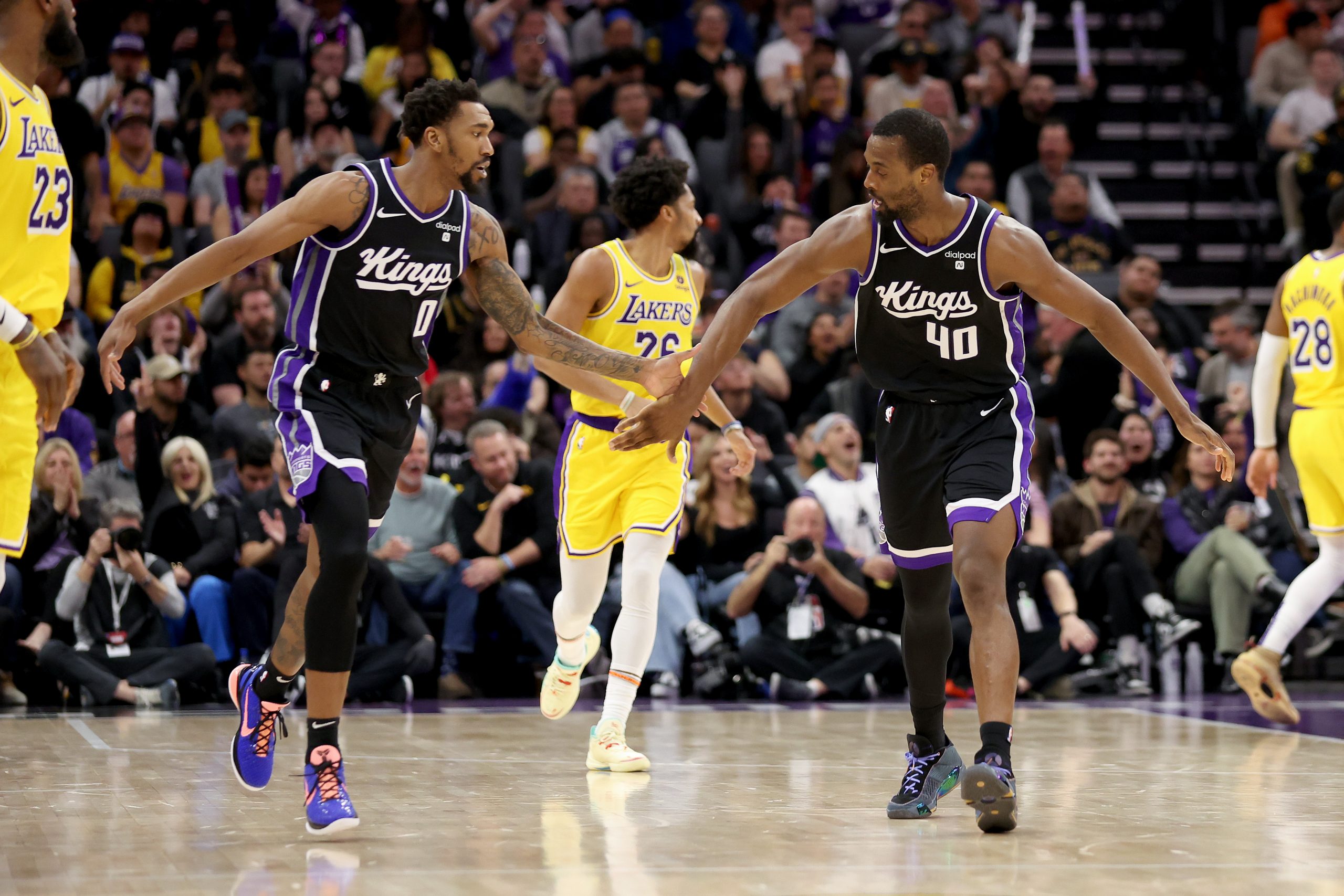 Malik Monk #0 and Harrison Barnes #40 of the Sacramento Kings high-five during their game against t...