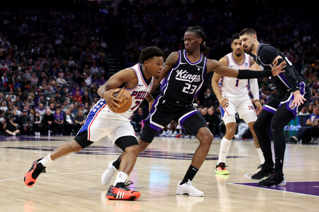 Kyle Lowry #7 of the Philadelphia 76ers is guarded by Keon Ellis #23 of the Sacramento Kings in the...