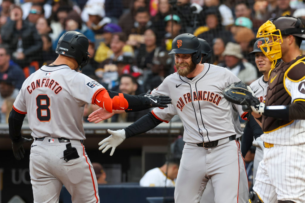 Michael Conforto #8 of the San Francisco Giants high-fives Austin Slater #13 after hitting a grand ...