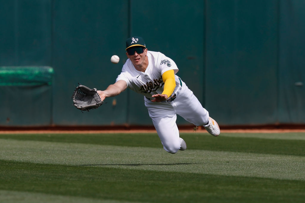 JJ Bleday #33 of the Oakland Athletics catches a line drive hit by Tyler Freeman #2 of the Clevelan...
