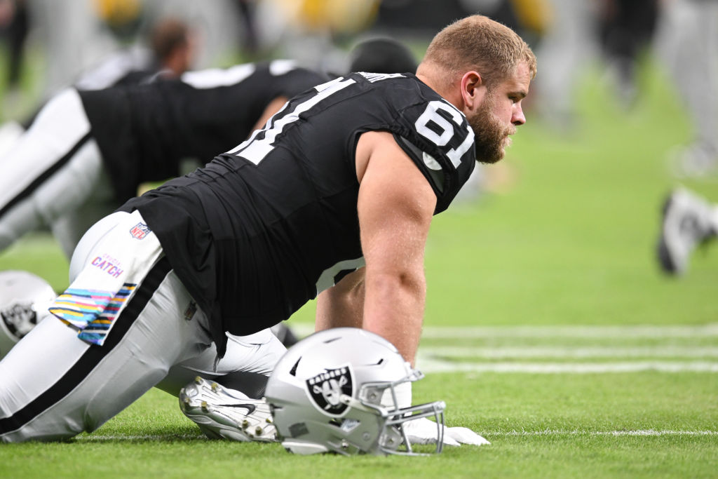 Jordan Meredith #61 of the Las Vegas Raiders stretches before the game against the Green Bay Packer...
