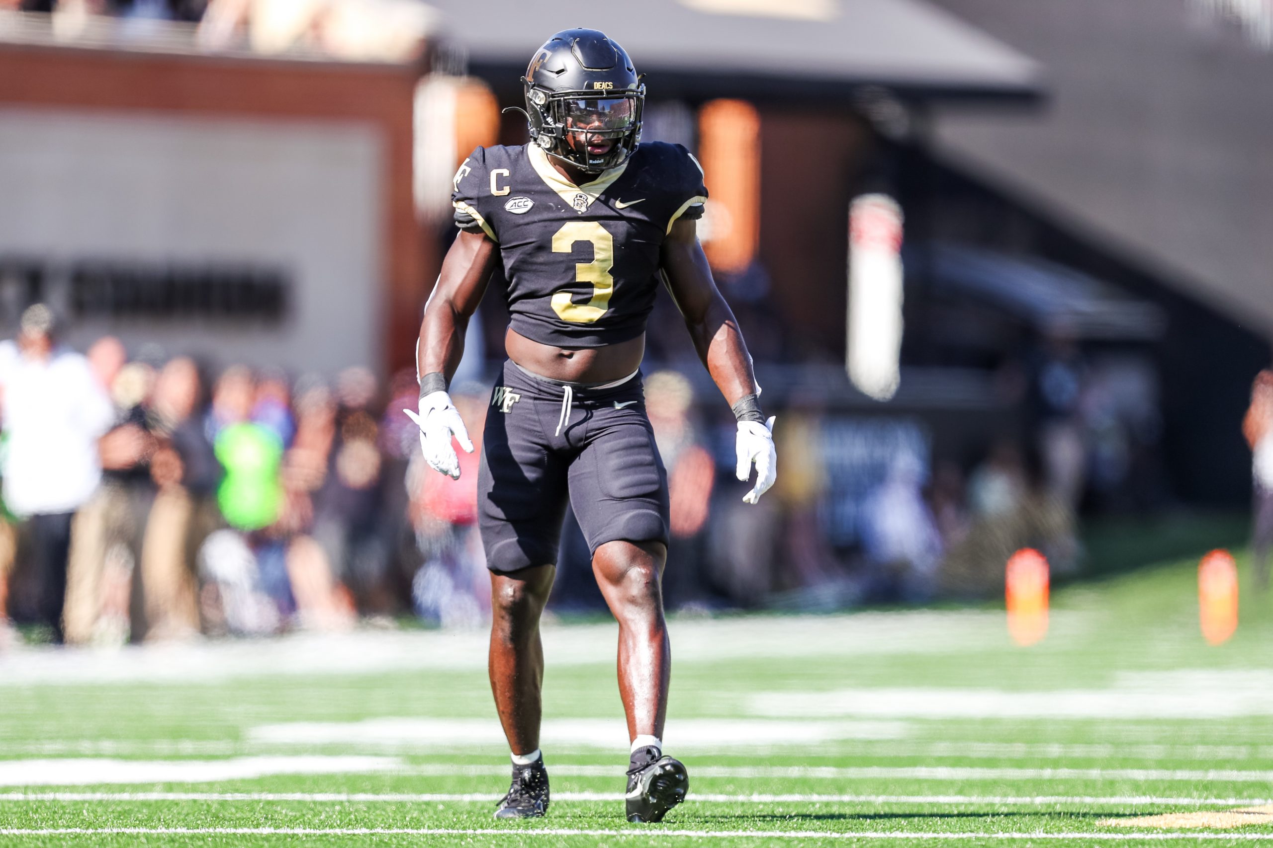 Malik Mustapha #3 of the Wake Forest Demon Deacons walks back to the line of scrimmage during a foo...