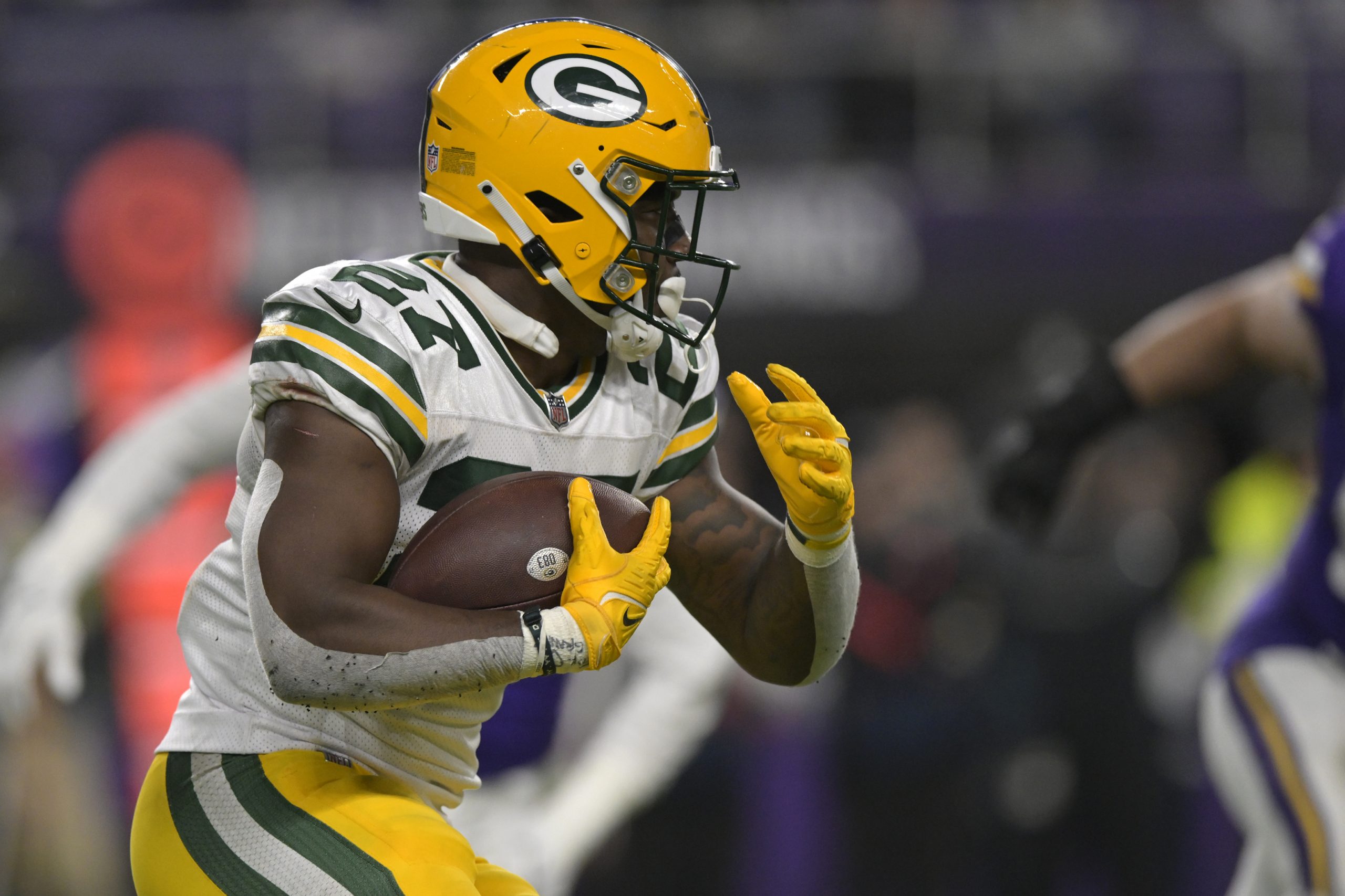 Green Bay Packers running back Patrick Taylor (27) runs with the ball during an NFL game between th...