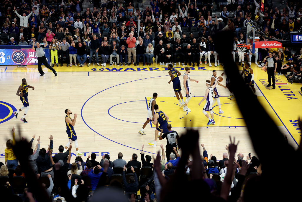 Stephen Curry #30 of the Golden State Warriors reacts after making a three-point basket against the...