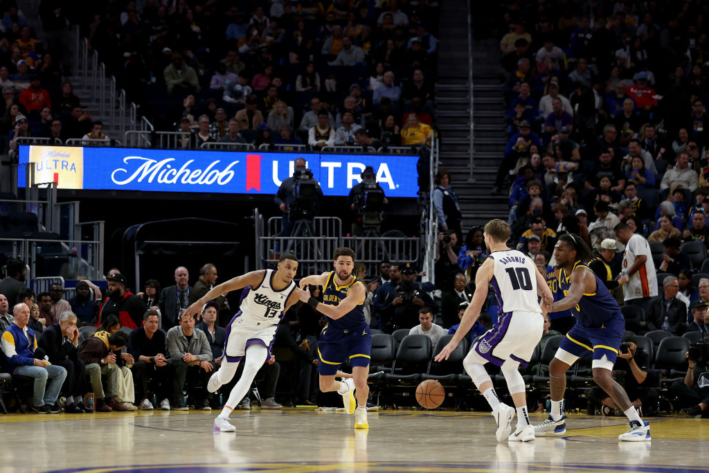 Keegan Murray #13 of the Sacramento Kings is guarded by Klay Thompson #11 of the Golden State Warri...