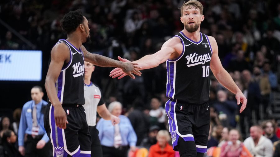 Domantas Sabonis #10 and Malik Monk #0 of the Sacramento Kings celebrate against the Toronto Raptors during the second half at the Scotiabank Arena on March 20, 2024 in Toronto, Ontario, Canada. NOTE TO USER: User expressly acknowledges and agrees that, by downloading and/or using this Photograph, user is consenting to the terms and conditions of the Getty Images License Agreement.