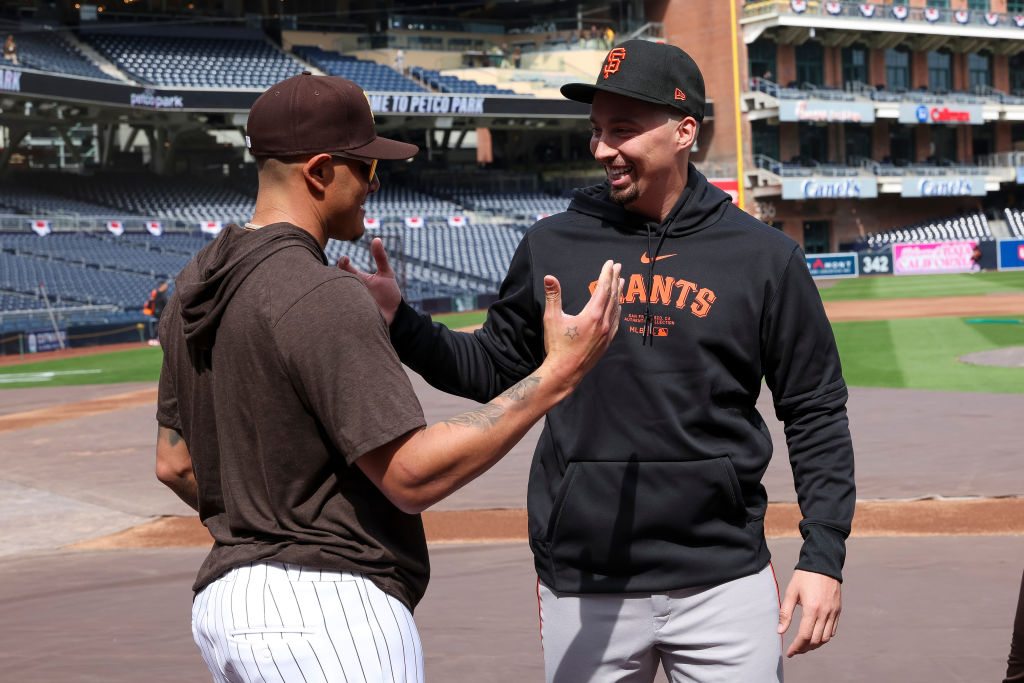 Manny Machado #13 of the San Diego Padres talks with Blake Snell #7 of the San Francisco Giants pri...