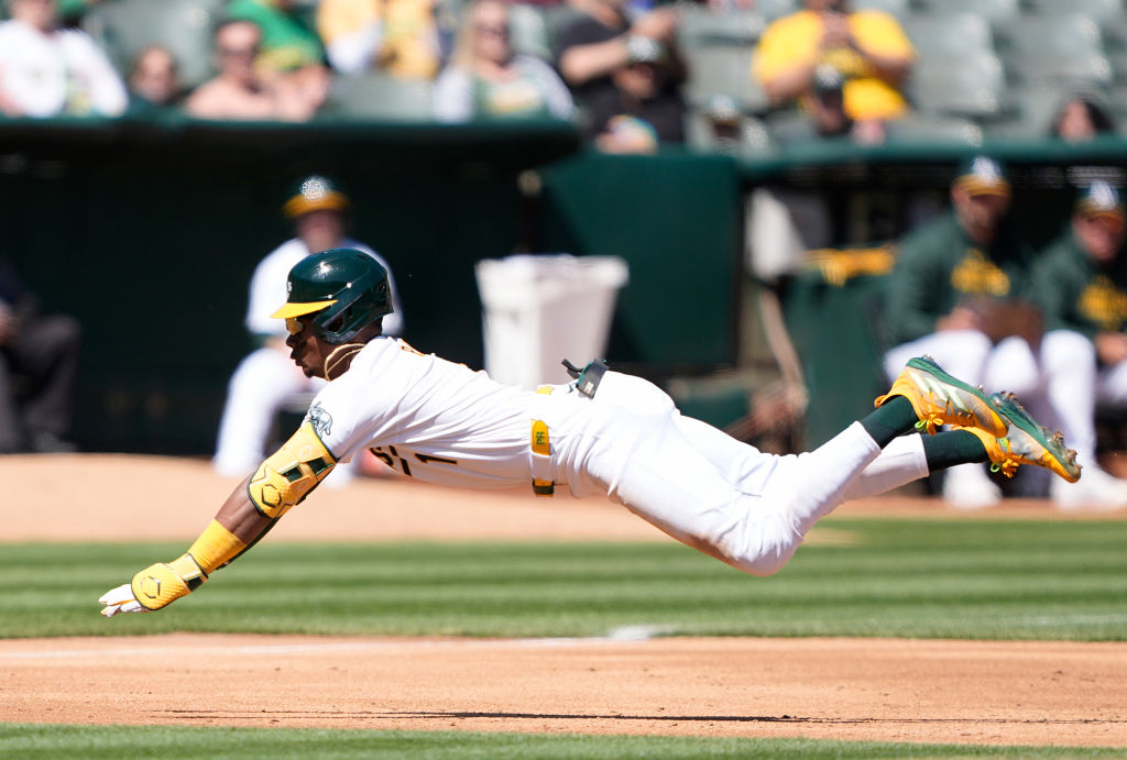 Esteury Ruiz #1 of the Oakland Athletics dives into third base with a triple against the Cleveland ...