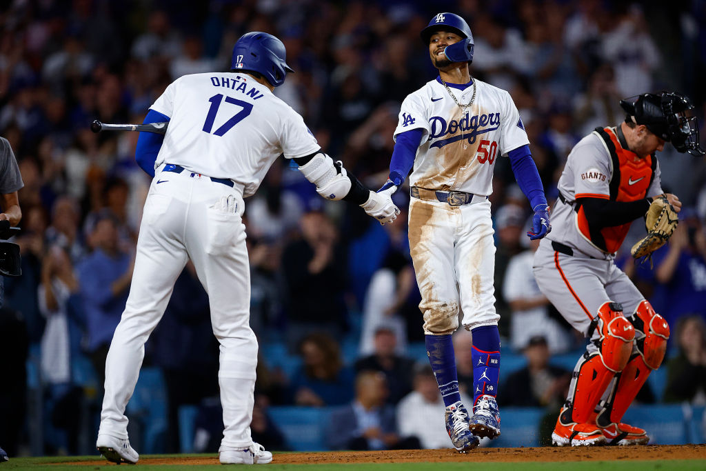 Mookie Betts #50 of the Los Angeles Dodgers celebrates a home run with Shohei Ohtani #17 against th...