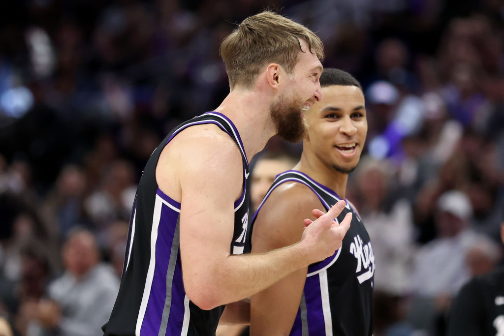 Domantas Sabonis #10 of the Sacramento Kings talks to Keegan Murray #13 during a time out of their ...