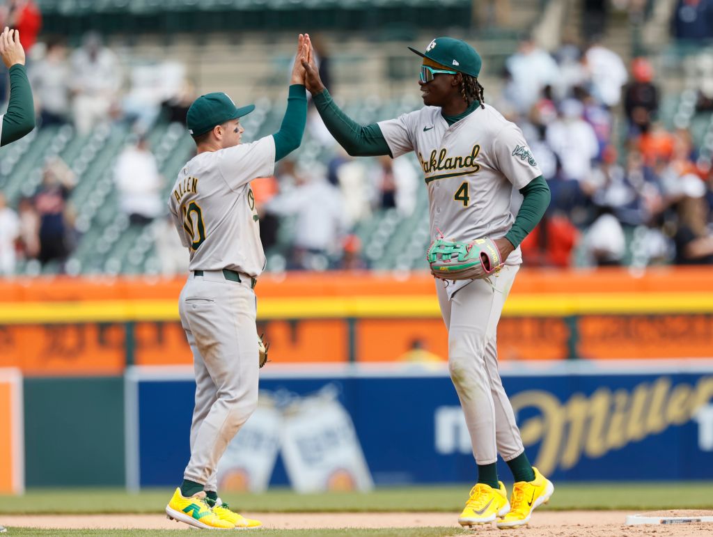 Zack Gelof #20 of the Oakland Athletics celebrates with Lawrence Butler #4 after a 7-1 win over the...