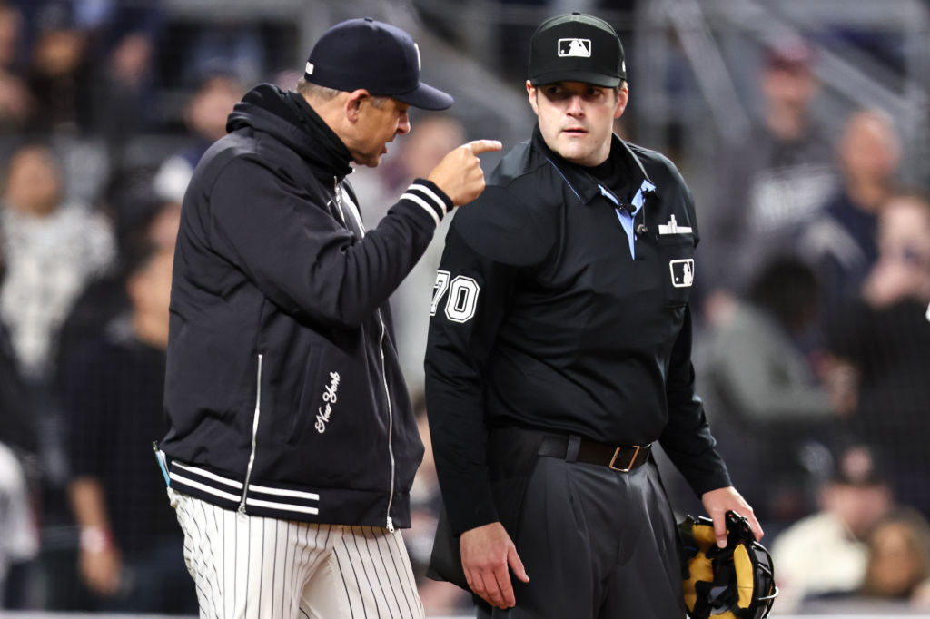 Manager Aaron Boone of the New York Yankees argues with home plate umpire John Bacon after being ej...