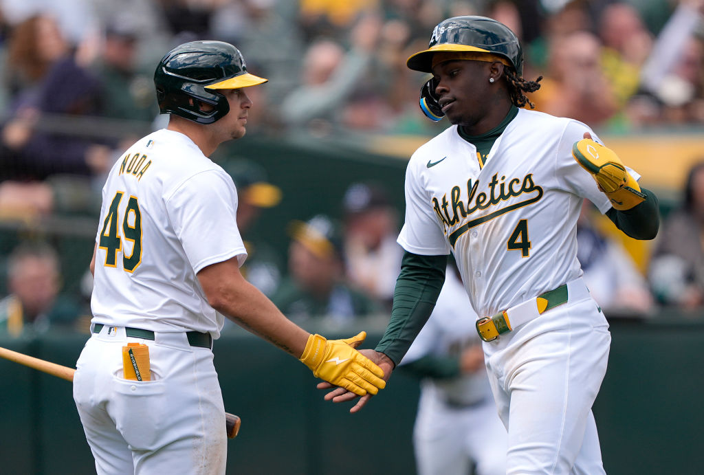 Lawrence Butler #4 of the Oakland Athletics celebrates scoring in the bottom of the fifth inning wi...