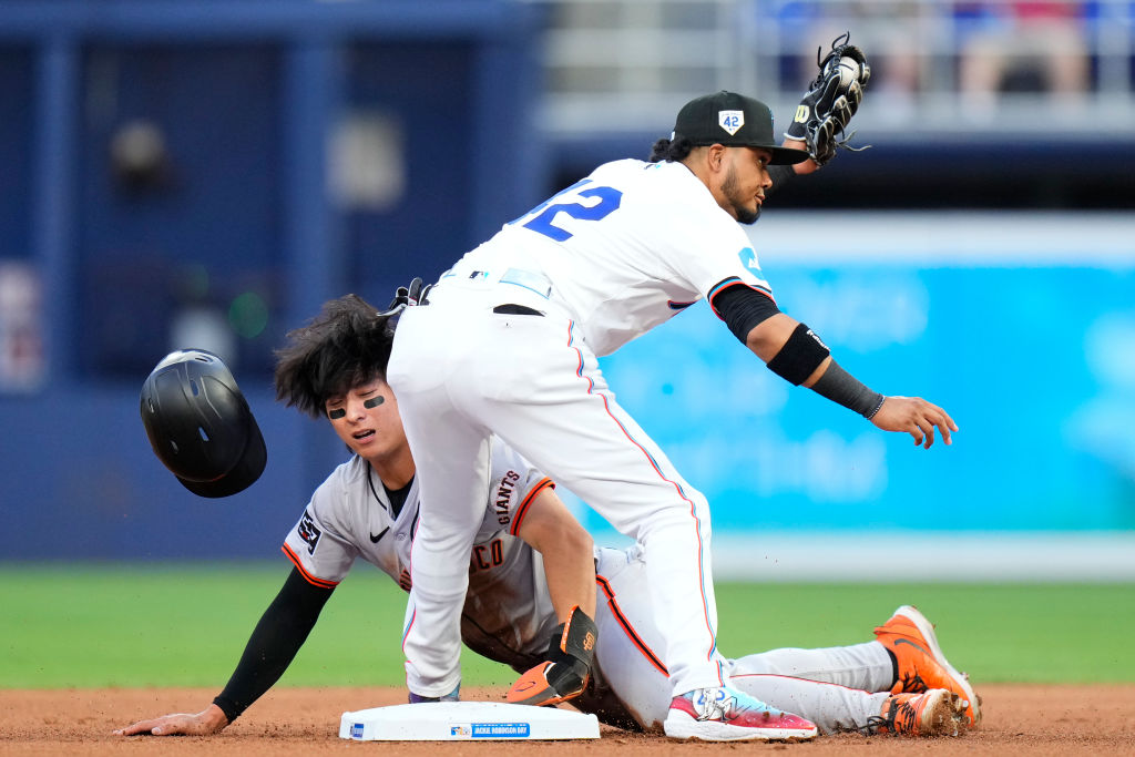 Luis Arraez #3 of the Miami Marlins tags out Jung Hoo Lee #51 of the San Francisco Giants during th...