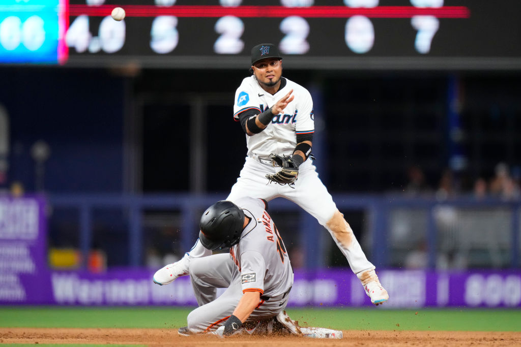Luis Arraez #3 of the Miami Marlins tags out Nick Ahmed #16 of the San Francisco Giants during the ...