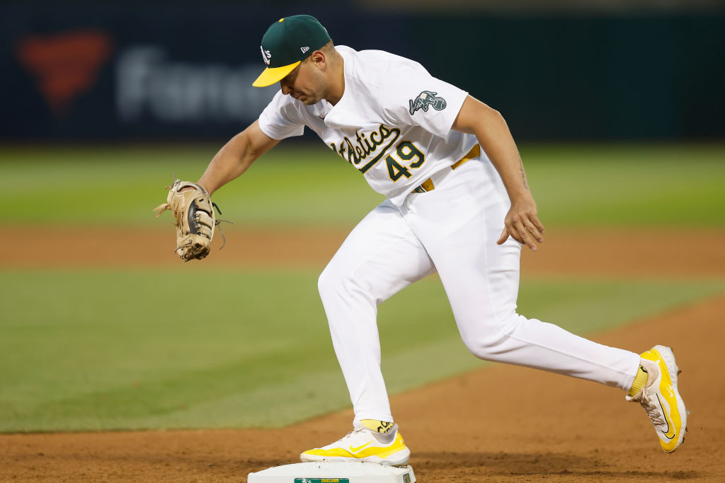 Ryan Noda #49 of the Oakland Athletics gets the out at first base on Brendan Donovan #33 of the St....