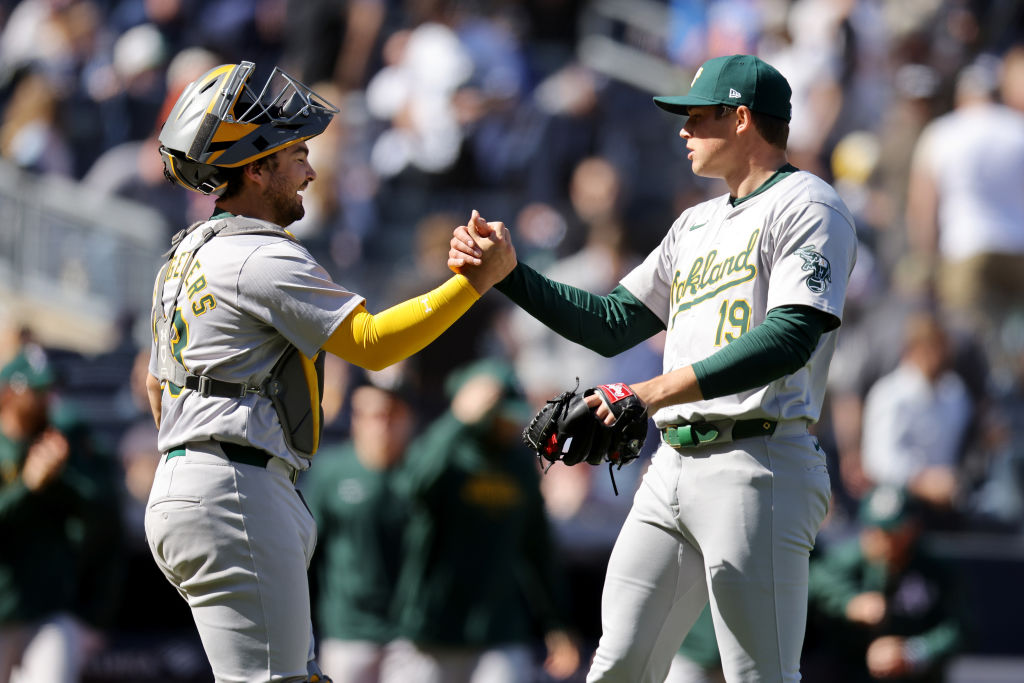 NEW YORK, NEW YORK - APRIL 22: Shea Langeliers #23 and Mason Miller #19 of the Oakland Athletics ce...