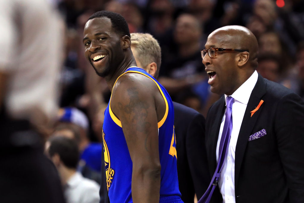 Draymond Green #23 of the Golden State Warriors and assistant coach Mike Brown react after a foul c...