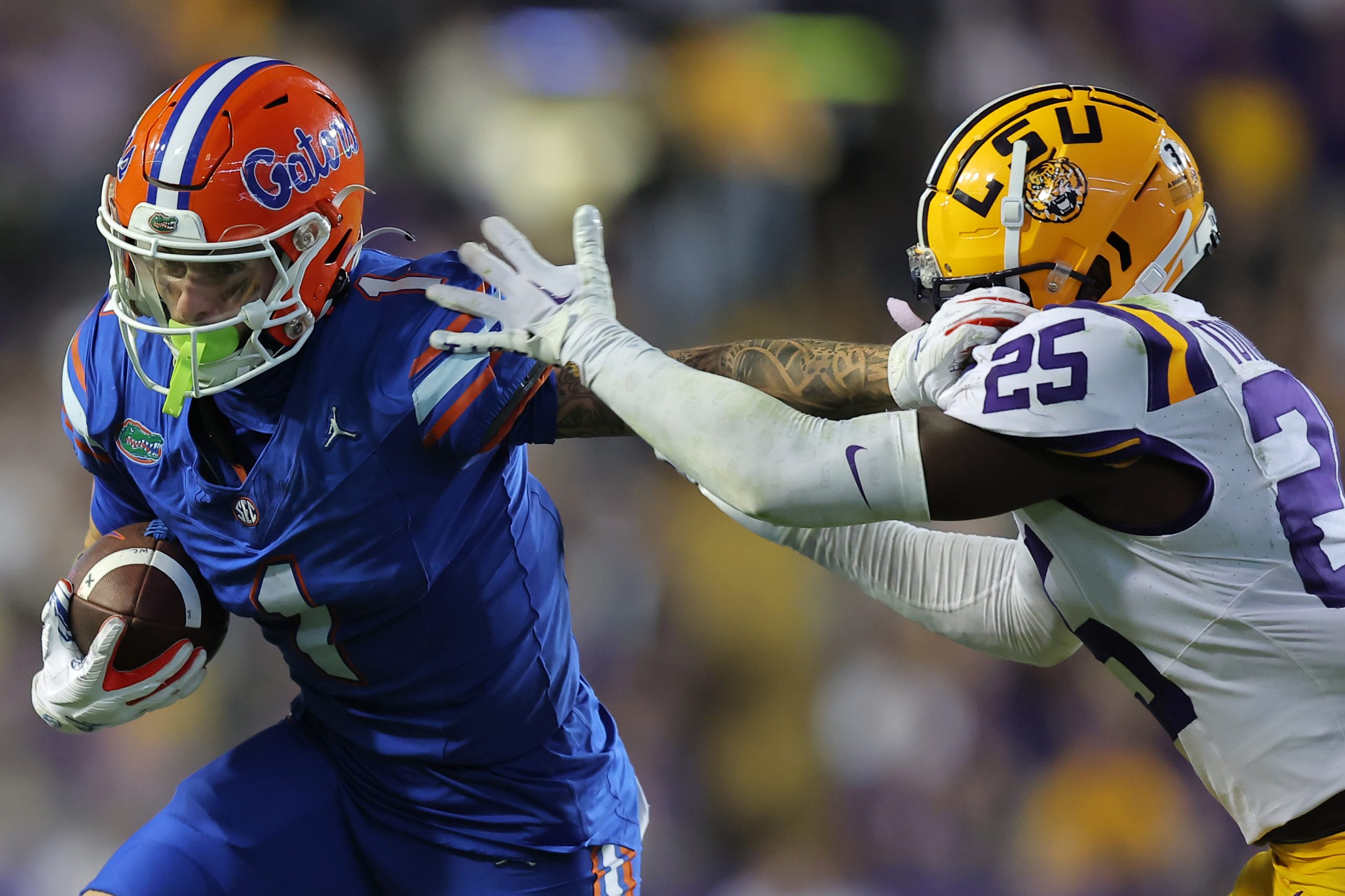 Ricky Pearsall #1 of the Florida Gators runs with the ball as Javien Toviano #25 of the LSU Tigers ...