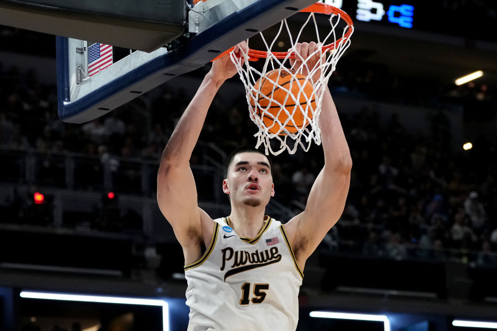 INDIANAPOLIS, INDIANA - MARCH 24: Zach Edey #15 of the Purdue Boilermakers dunks the ball against t...