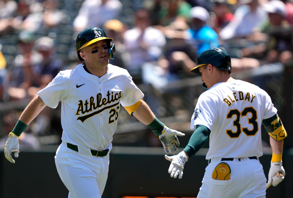 OAKLAND, CALIFORNIA - MAY 01: Tyler Nevin #26 of the Oakland Athletics is congratulated by JJ Bleda...