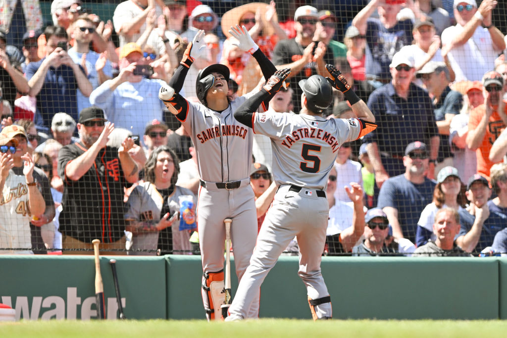 BOSTON, MASSACHUSETTS - MAY 02: Mike Yastrzemski #5 of the San Francisco Giants reacts with Jung Ho...