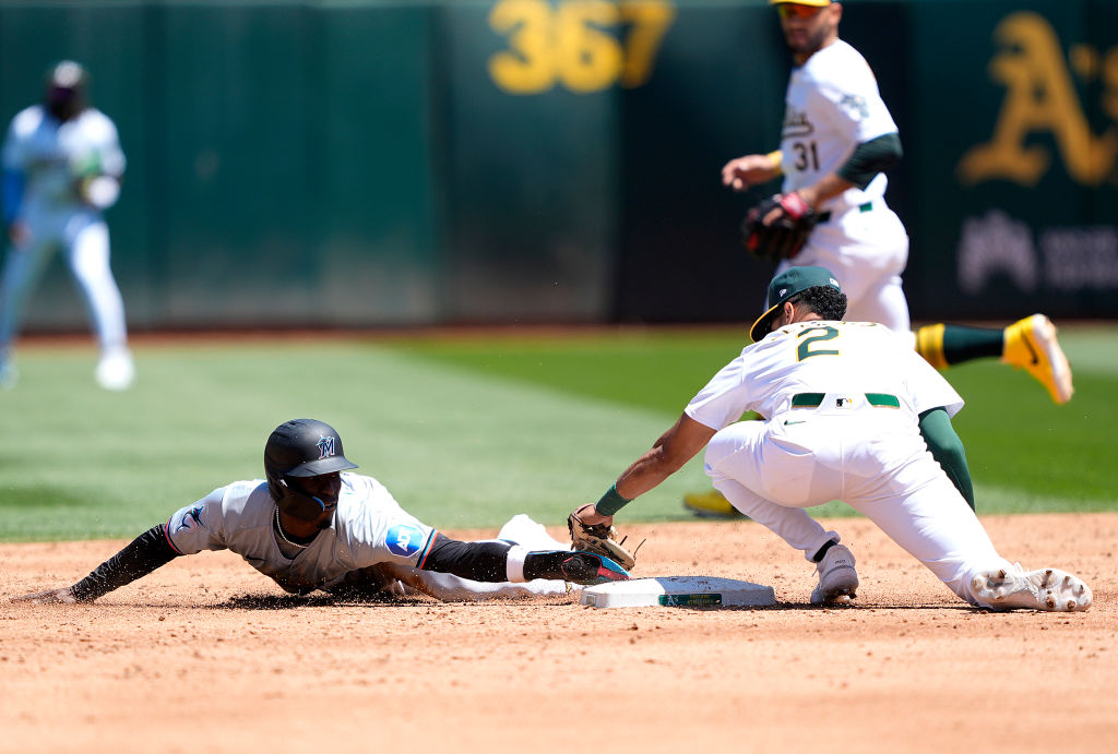 OAKLAND, CALIFORNIA - MAY 05: Nick Gordon #1 of the Miami Marlins attempts to steal second base and...