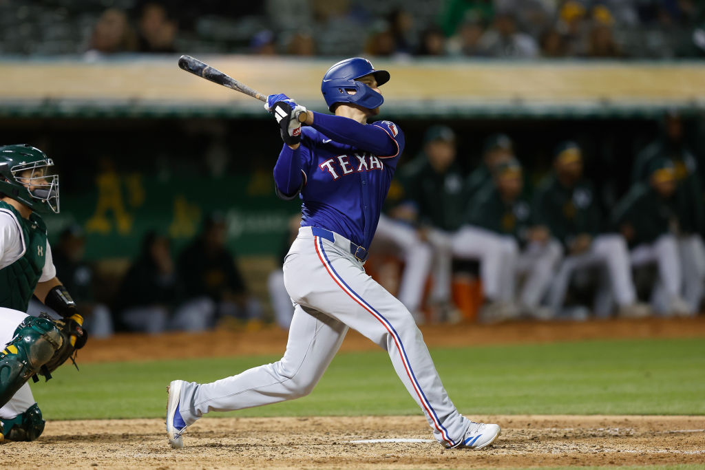 OAKLAND, CALIFORNIA - MAY 06: Corey Seager #5 of the Texas Rangers hits a three-run home run in the...