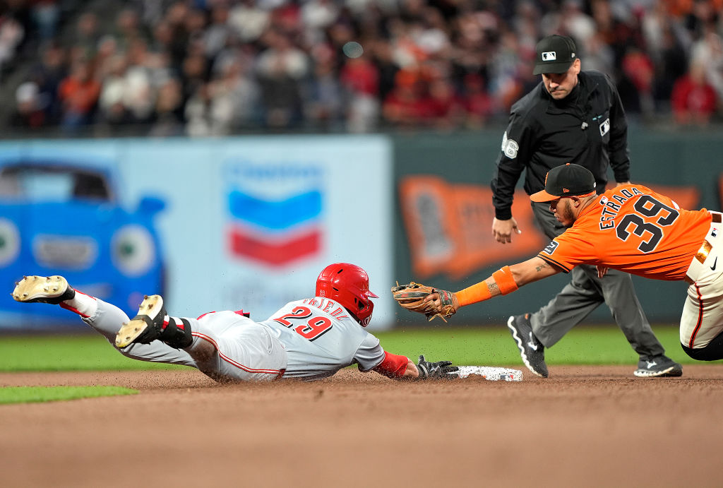 SAN FRANCISCO, CALIFORNIA - MAY 10: TJ Friedl #29 of the Cincinnati Reds dives into second base wit...