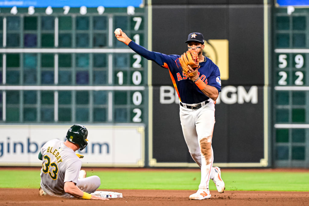 HOUSTON, TEXAS - MAY 15: Jeremy Peña #3 of the Houston Astros turns a double play in the eighth in...