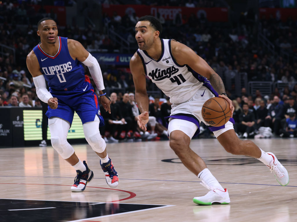 LOS ANGELES, CALIFORNIA - DECEMBER 12: Trey Lyles #41 of the Sacramento Kings dribbles past Russell...