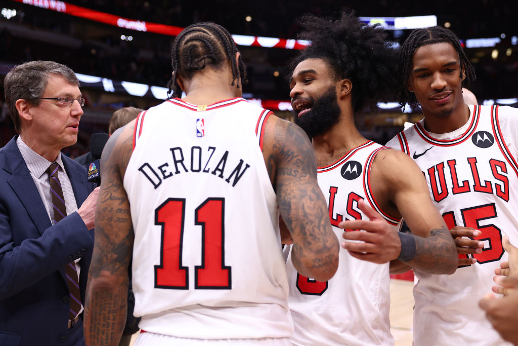 CHICAGO, ILLINOIS - FEBRUARY 28: Coby White #0 and DeMar DeRozan #11 of the Chicago Bulls celebrate...