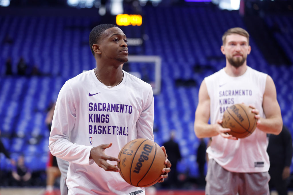 SACRAMENTO, CALIFORNIA - APRIL 14: De'Aaron Fox #5 and Domantas Sabonis #10 of the Sacramento Kings...