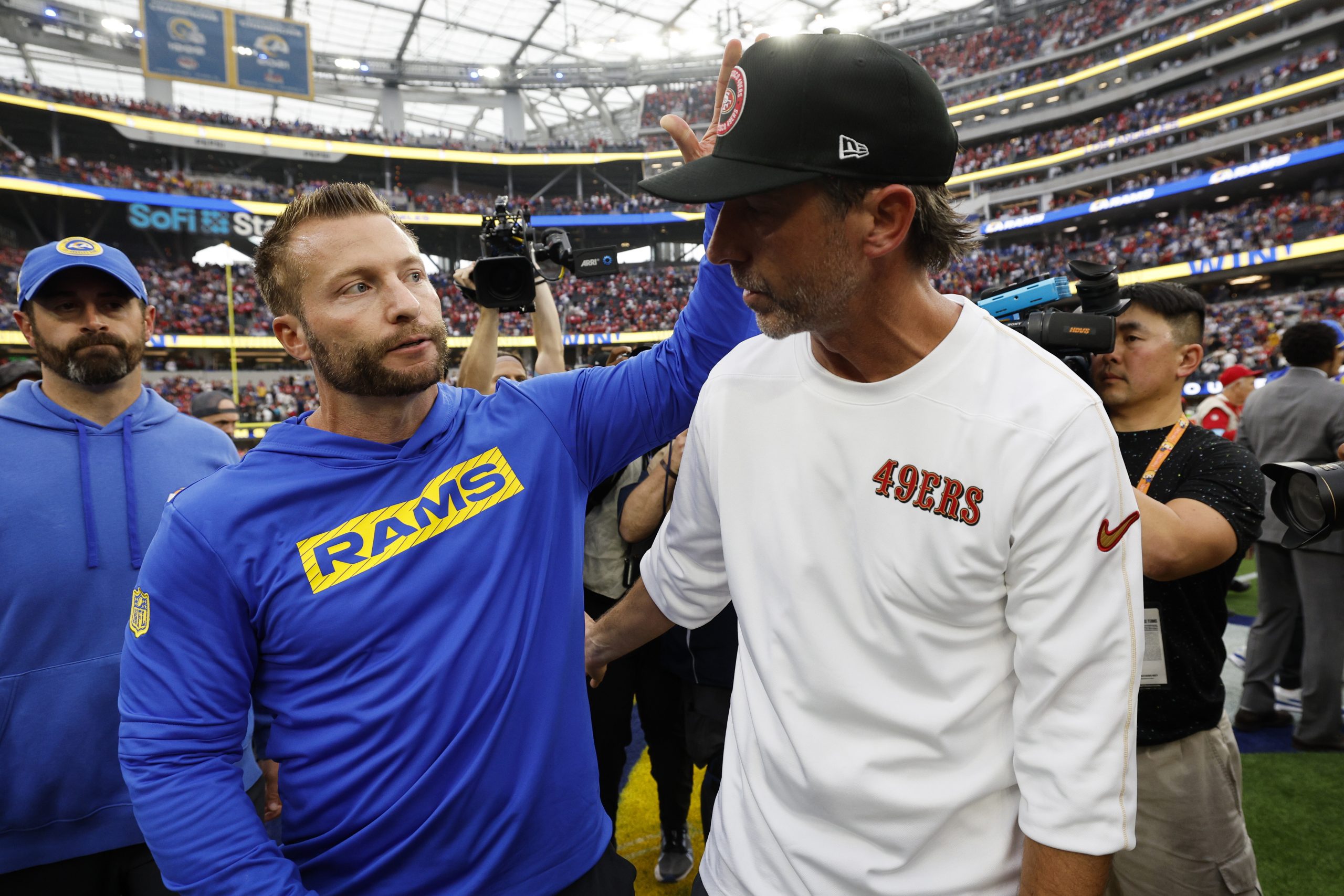 Sean McVay, head coach of the Los Angeles Rams, embraces Kyle Shanahan, head coach of the San Franc...