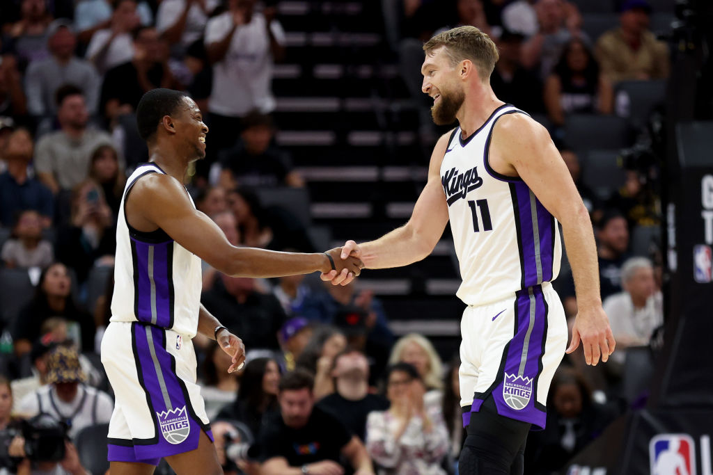 SACRAMENTO, CALIFORNIA - OCTOBER 09: De'Aaron Fox #5 shakes hands with Domantas Sabonis #11 of the ...