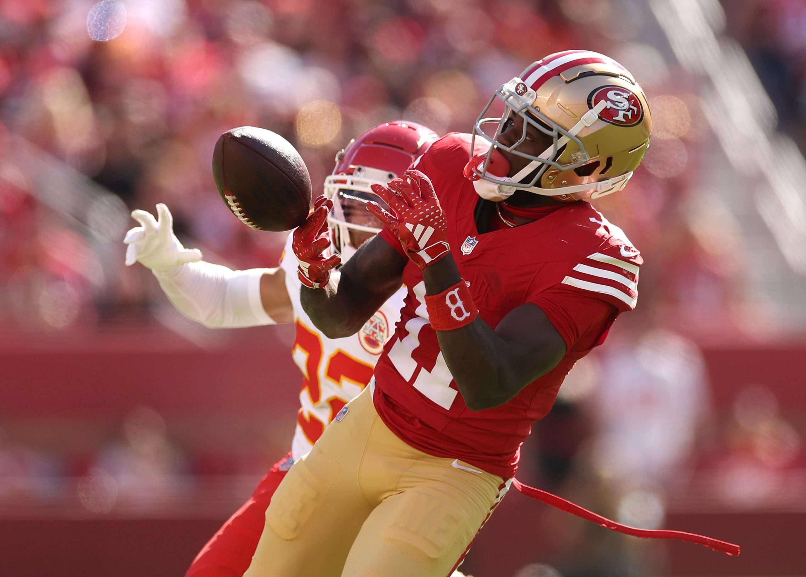 Brandon Aiyuk #11 of the San Francisco 49ers drops a pass in front of Trent McDuffie #22 of the Kan...