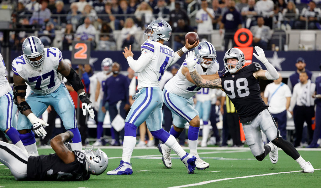 ARLINGTON, TEXAS - NOVEMBER 25: Dak Prescott #4 of the Dallas Cowboys throws under pressure from Ma...