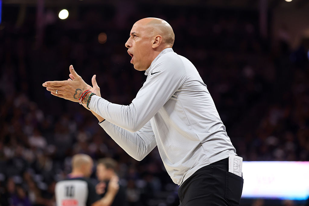 SACRAMENTO, CALIFORNIA - OCTOBER 24: Head coach Doug Christie of the Sacramento Kings cheers on his...
