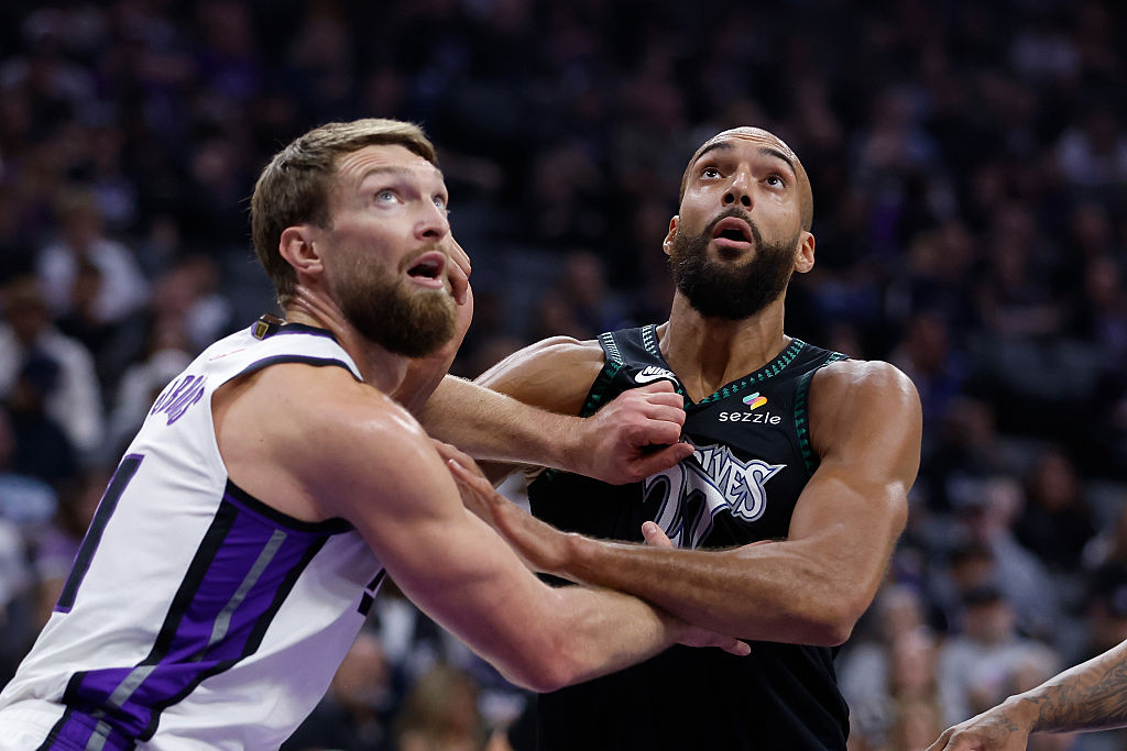 Domantas Sabonis #11 of the Sacramento Kings and Rudy Gobert #27 of the Minnesota Timberwolves comp...