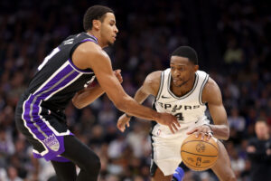 SACRAMENTO, CALIFORNIA - MARCH 07: De'Aaron Fox #4 of the San Antonio Spurs is guarded by Keegan Murray #13 of the Sacramento Kings at Golden 1 Center on March 07, 2025 in Sacramento, California. NOTE TO USER: User expressly acknowledges and agrees that, by downloading and/or using this photograph, user is consenting to the terms and conditions of the Getty Images License Agreement. (Photo by Ezra Shaw/Getty Images)