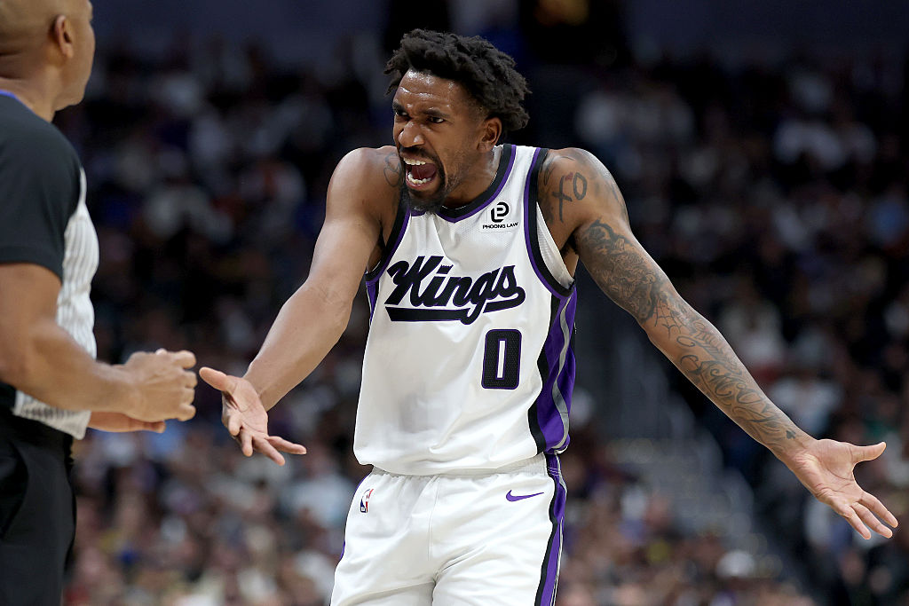 DENVER, COLORADO - NOVEMBER 22: Malik Monk #0 of the Sacramento Kings looks for a foul while playin...