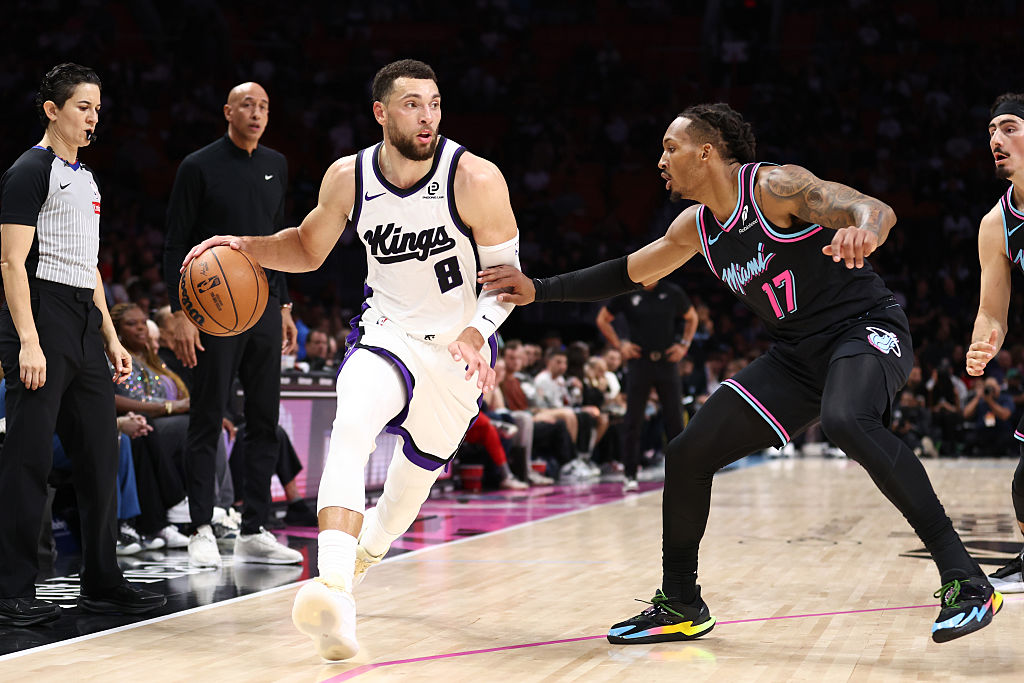 MIAMI, FLORIDA - DECEMBER 06: Zach LaVine #8 of the Sacramento Kings drives against Jahmir Young #1...
